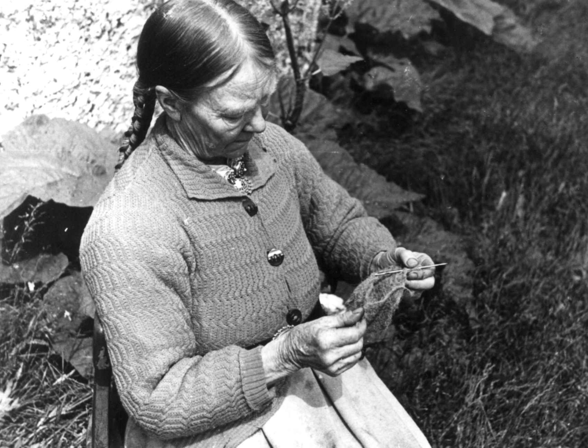 Valle, Setesdal, Aust-Agder 1939. Portrett av Annlaug K. Haugen som sitter med nålebinding.