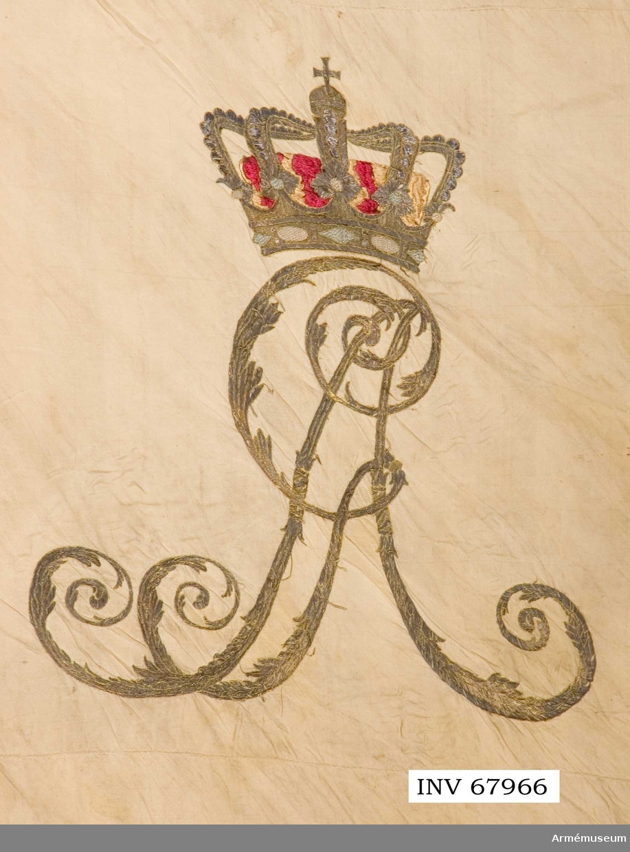 Duk:
Tillverkad av vit sidenkypert, hopsydd av tre längsgående våder.  
Duken kantad av en snodd, gjord av fyra snoddar. Fäst vid stången med en rad tennlikor på ett mönstervävt snoddband.
 
Dekor:
Broderad i guld omvänt lika på båda sidor, Gustav IV Adolfs namnchiffer under sluten kunglig krona, med ytter och innerfoder i rött silke. I hörnen slutna kronor.

Stång: 
Ljusgrå. 

Holk:
Ciselerade pärlrandslister. Påminner om den på dragonfana nr 16953 (AM.068088).

Spets saknas (har förmodligen varit av förgylld mässing).