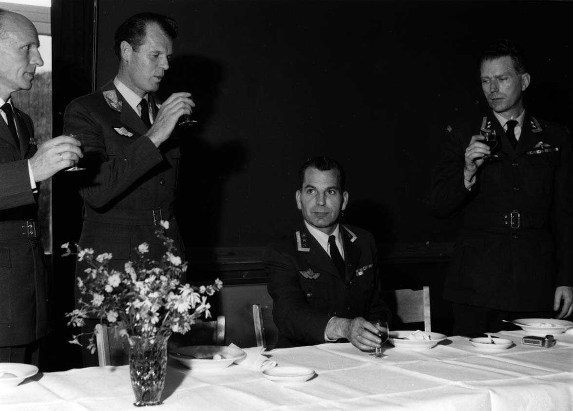Gruppe.  Stasjonssjefskifte Ob. Heine Eriksen - Ulleberg .  Fire personer  i uniform ved et bord.