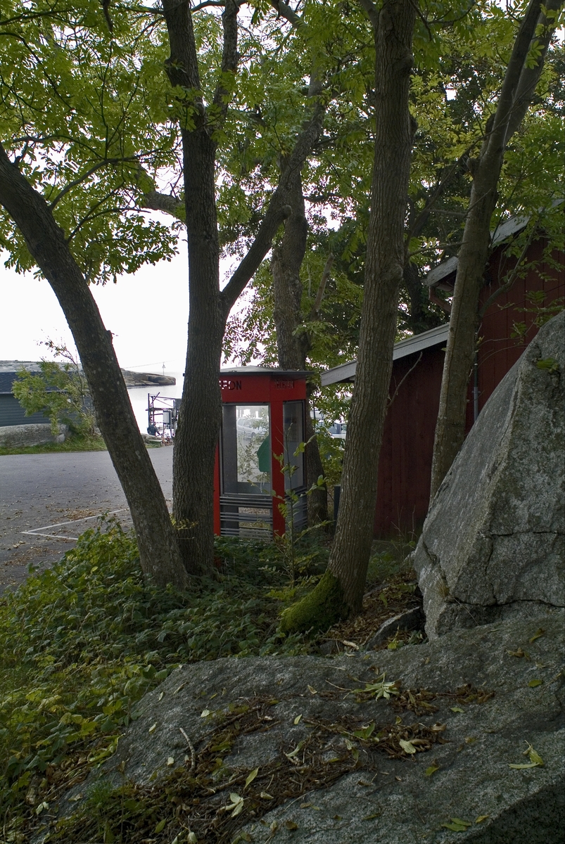 This is the story of how Norway’s most important conversation-space was designed by a young, freshly graduated man from Bergen.

“Norwegian architects are hereby invited…”
In the autumn of 1932, Oslo Telefonanlegginitiated an architectural competition. Finally, Oslo would get its own telephone booth. The city had had so called “talking-stations” from 1885, which in turn were overtaken by automatic telephones  only available at selected Narvesen kiosks. The state was of the opinion that now was the time to offer the public a better service; public telephone booths open 24/7, like the ones they already had in Sweden and England. But what would they look like, these new telephone booths? What considerations would it be necessary to take when designing it? The telegraph board developed a detailed list of demands and restraints: “The booth is intended to be placed outside on the streets and squares and need to be designed so that snow and ice does not hinder the opening and closing of the doors,” they wrote. “To prevent vandalism, theft, uncleanliness etc. inside the booth, it needs to be designed so that from all angles one may see what is going on in there.” Additionally, it would need to withstand storms and bad weather, and “preferably also being whipped by rain mixed with seawater” 

This was not all: The appearance would have to be «pleasing». The booth also needed to be movable, so that it could be taken in to be serviced at Telegrafverket’s main workshops. The reqired material was iron, and the surface was to be spray painted  preferably using car-body paint. There was a requirement for “a writing shelf, a pack shelf, and a suitable place for the telephone catalogue.” Also, there would need to be an illuminated TELEFON  sign, easily visible from all four angles. The total cost for each booth should not exceed 1000 kroner. The first prize for coming up with such a product was 800 kroner.

“Norwegianarchitects are hereby invited to partake in a competition for the design of a telephone booth…”  

The man with the solution
«At some point in 1932, Georg Fredrik sat at a party in Bergen. Maybe he felt a bit lost and forgotten as he often had throughout his life. He retreated to a quiet corner, took out a pencil and strted doodling on a matchbox.  According to my mother, this was how the telephone booth came into being.” In the book “Norges lille røde  historien om telefonkiosken,” Lars Fasting describes his father, the man who is far less known than the iconic architctural structure he left behind. Georg Fredrik Fasting was from Bergen, born into a family of working people and smallholders. One unusual facet of Georg Fredrik was that he was born without ears. His mother made sure he learnt to speak, read and write, ut Lars Fasting indicates that his father would seek refuge in drawing when the social challenges became too much to bear. And in the end drawing became his profession. In 1924 he secured a guarantor for a student loan, and started studying to become an architect at the NTH. Throughout the 1930s he entered several architectural competitions, with drafts produced, according to his son, “after work and in the late hours of the night.”

His efforts were not wasted. Out of 93 entries, with names such as “Flirt”, “Brrr”, “Ring” and “Amor”, the jury selected Fasting’s submission, “RIKS” as the new telephone booth: “The draft shows a strikingly simple solution to the task, technically as well as aesthetically well worked out.”

Taut and provident
Simple and aesthetc are the keywords here. Fasting had designed a booth pointing towards the future, and to modernism. Just how modern it was can be seen by comparing RIKS to the British telephone booth, also designed in the interwar-era. While the British version with it classicistic style is looking back to the heyday of the empire, Fasting’s booth is progressive and functionalistic. Like most Norwegian architects, Fasting broke with the classicistic style of architecture after the Stockholm-exhibition in 1930. “After it, almost all buildings erected in Norway until the German invasion in 1940, were in the functionalistic architectural style,” writes senior curator of architecture at the Norwegian National Museum, Ulf Grønvold, in the book, “Den lille røde”.“TheNorwegian booth is a piece of functionalistic architecture, an asymmetric composition with its roof slab overhanging the word TELEFON, in bold sans seraph lettering,”concludes Ulf Grønvold.

Fashionably red
And it was red. Fasting chose a colour which was part of the modern palette. “A bright red colour, but not as shiny as a signal red, the character of the colour places it among the fashionable colours within functionalism,” states paintings conservator and researcher in NIKU (Norwegian Institute for Cultural Heitage Research), Jon Brænne. In his opinion, Fasting went for visibility without making the booth stand out too much from its surroundings. The original colour was in use up to around 1950, when it changed to signal red. Towards the end of the 1970s the clour was again adjusted towards today’s orangey red.

The design, however, has not changed. RIKS is eighty years and still looks remarkably good. That’s what makes Fasting’s telephone booth a classic  even before it was added to DOCOMOMO’s list over moden icons of design. For Telenor, the telephone booth has served as a pathway into the hearts of the public. For many, Telenor (Televerket) was synonymous with exactly this telephone booth, because this was where one would go to place a call. Having a homephone was not common until the 1980s. As such the red box became part of the Norwegian everyday and consciousness. The symbol- and publicity value of this is hard to evaluate, but in 2007 it was time to give honour where honour was due, Telenor, in consultation with the Directorate for Cultural Heritage, decided to preserve 100 telephone booths for all eternity.

And what about Georg Fredrik Fasting? What happened to him? At the age of 56 an entry in his diary states: «I CAN HEAR». As the first person in th world he had undergone an operation where he had ear canals constructed and eardrums fitted. For the rest of his life, the man behind Norway’s own telephone booth could answer the telephone himself.

Source: Norges lille røde historien om telefonkiosken (2007), issued by The Norwegian Telecom Museum and Telenor Cultural Heritage.
