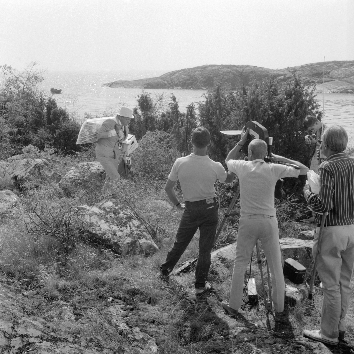 Ögonblick från inspelningen av filmen Skrållan, Ruskprick och Knorrhane i regi av Olle Hellbom. I rollen som smugglaren Knorrhane ser vi Tage Danielsson. Filmen spelades in på Källskär i Gryts skärgård sommaren 1967.