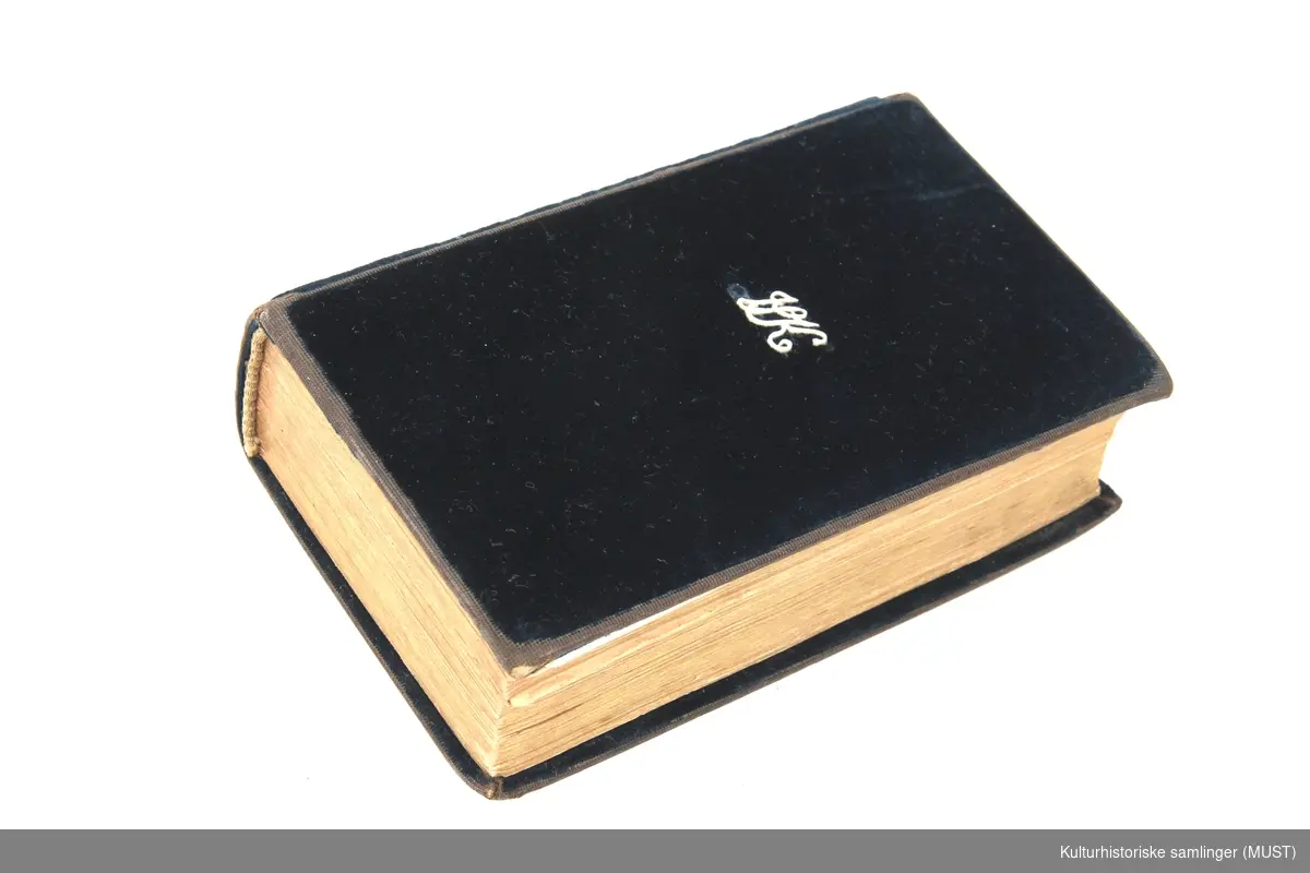 Liten salmebok med omslag i sort fløyel med monogram.