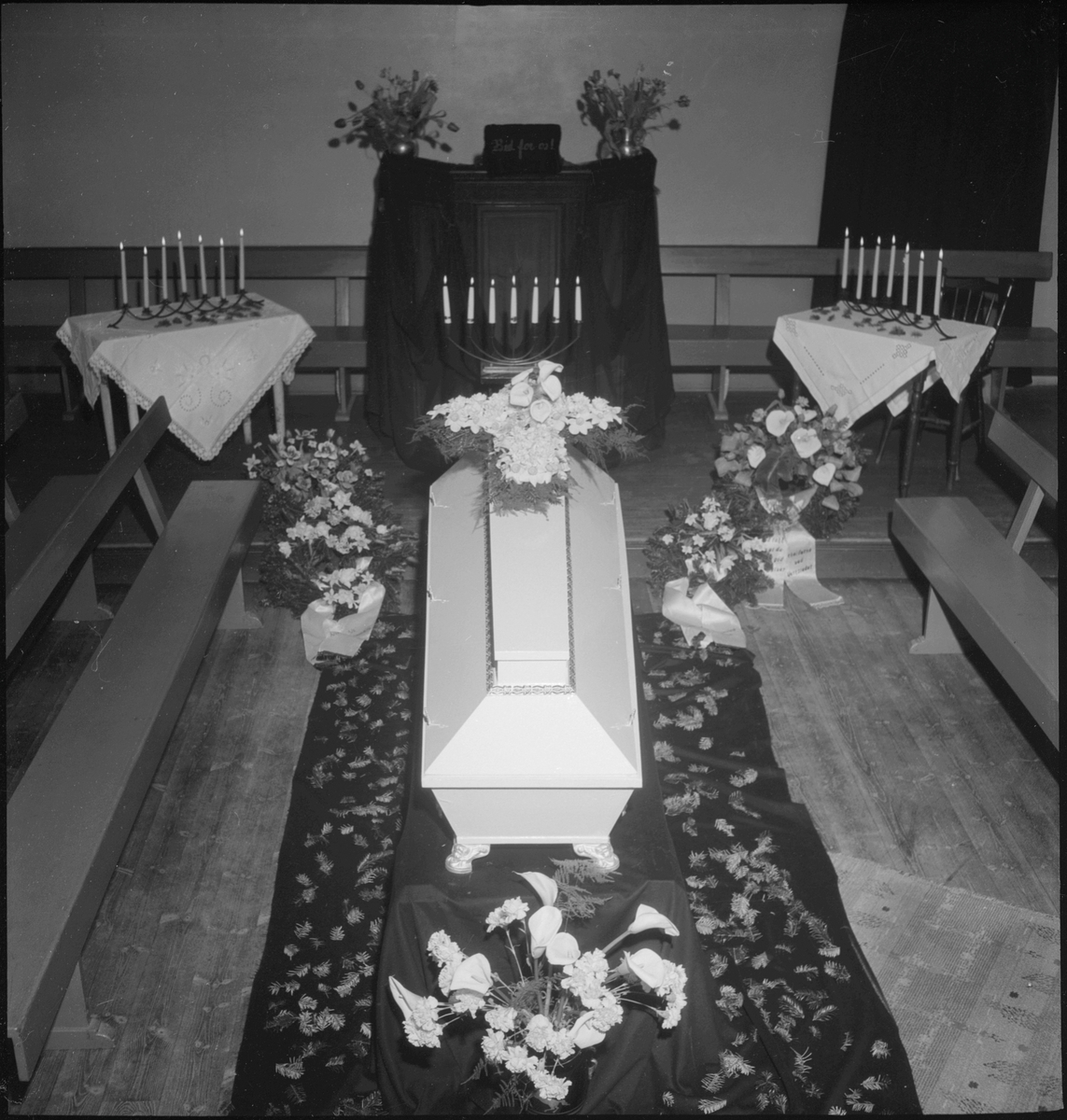 Begravelse i nærheten av Egersund. Det er bilder av kista med blomster, og av seremonien med folk som følger den døde til graven.
