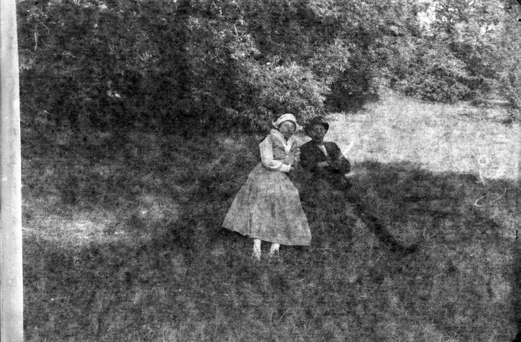 En man och en kvinna ligger i en grässlänt.