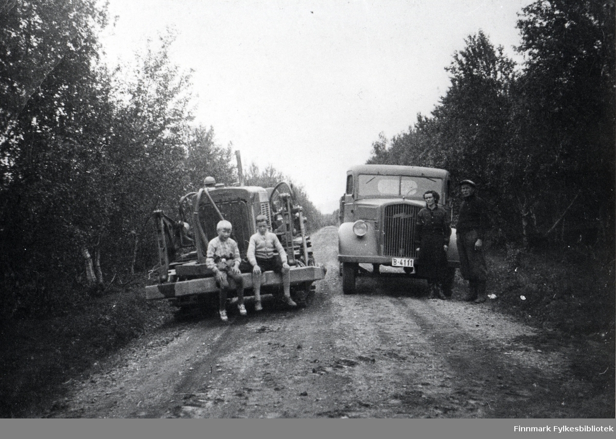 Transport av Cat beltetraktor. Hjørdis og Jakob Karlsen ved Opel Blitz astebilen (reg.skilte B-4111), barna ukjente. Året er ca. 1935 (?).