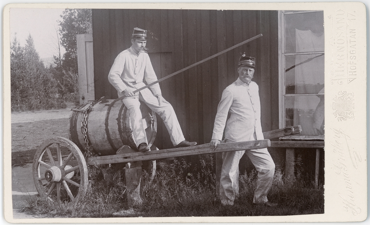 Kabinettsfotografi - två män i uniform och en kärra, Sånga 1897