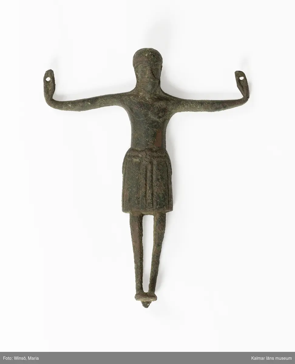 KLM 7960. Kristusbild. Av brons. Kristusbild avsedd att fästas på krucifix, gjuten med ihålig baksida. Långt ländkläde om midjan.