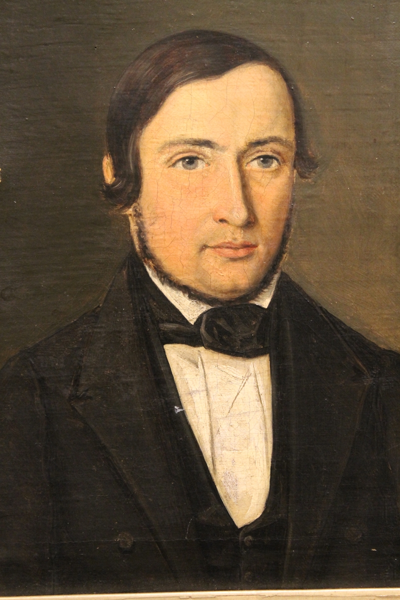 Portrett av mann i halvfigur vendt mot venstre. Hvit skjorte og sort vest