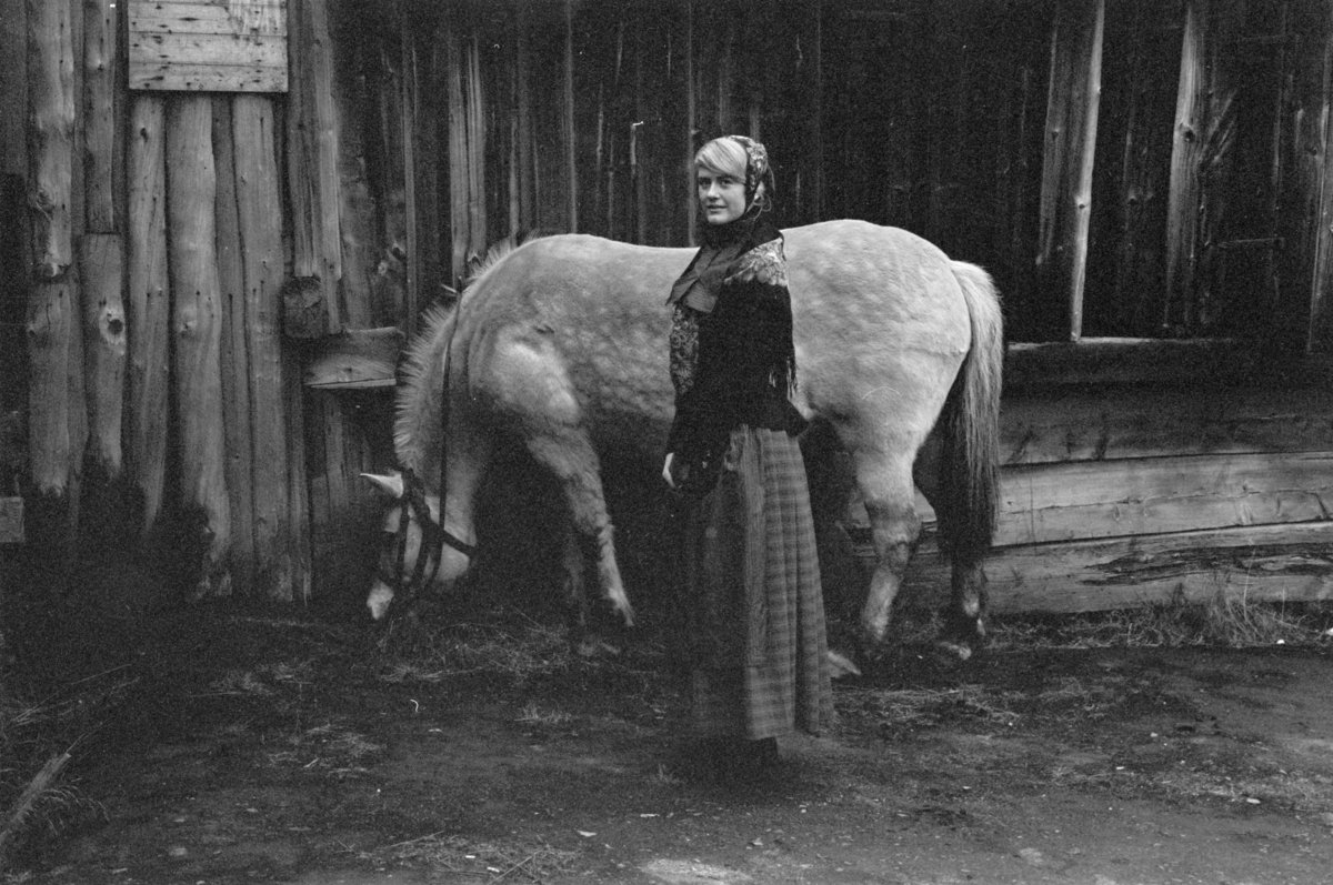 En kvinne i Røros-stakk med hest