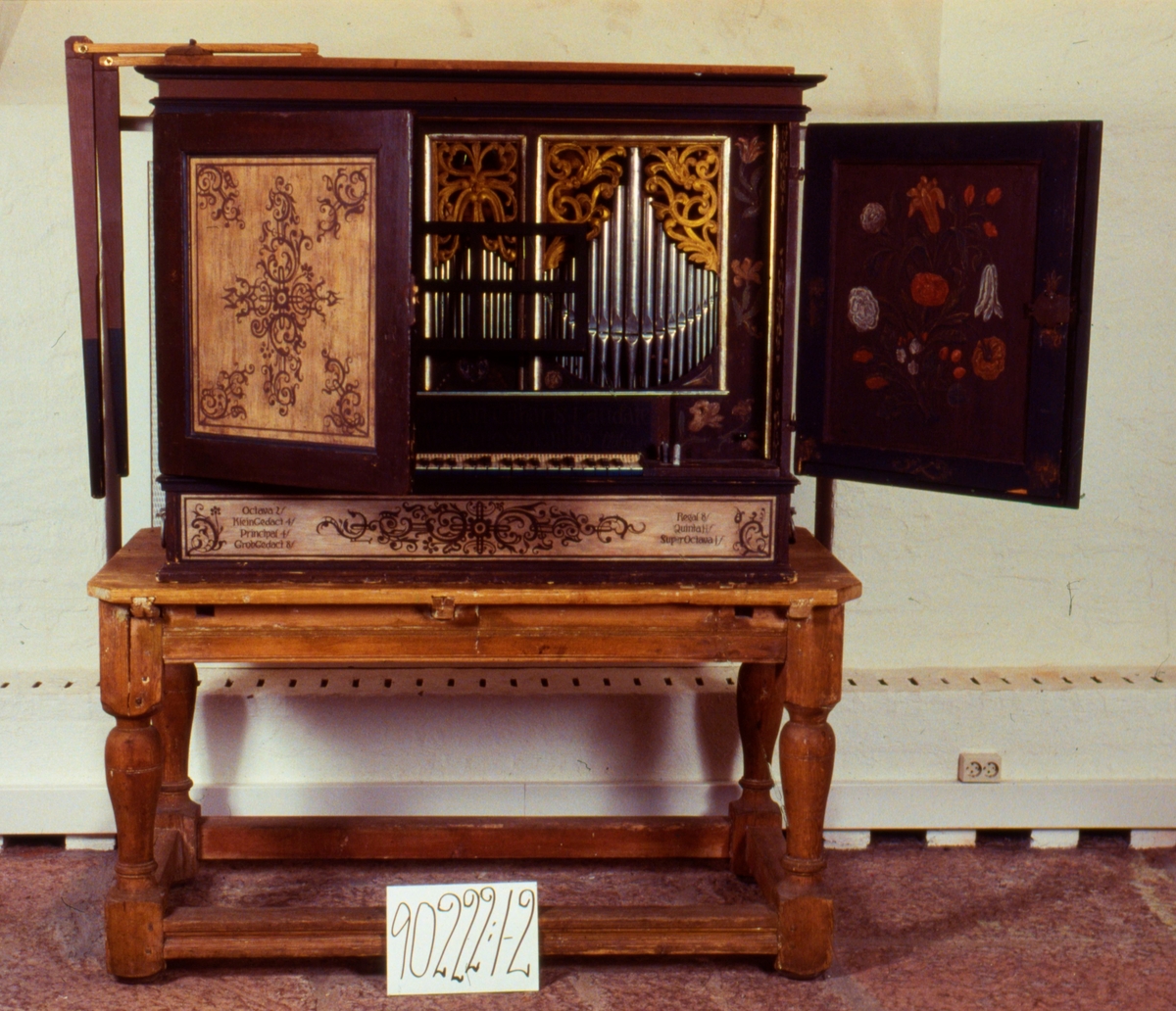 1) Bärbar orgel med fyra bärhandtag av järn, två på vardera sidan.
Orgeln är inbyggd i ett vacket målat skåp med två luckor på framsidan. Brun sirlig blomdekor på ljusbotten.
2) Bord av trä, klumpigt, ej ursprungligt.
Engelskt instrument troligen tillverkat vid mitten av 1600-talet av Nicolaus Manderscheidt i Nürnberg.
Orgeln skänktes ursprungligen av Per Brahe till Visingsös kyrka och hamnade sedan i Bjurums kyrka. 
Renoverad av Mats Kjersgaard på 1970-talet.
Se särskild kapsel om Bjurumsorgeln i arkiv