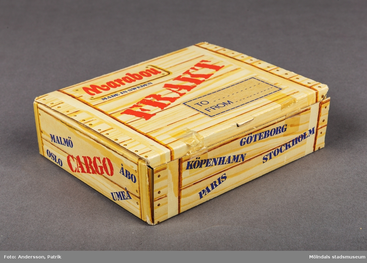 En ask i kartong som tidigare innehållit olika sorters choklad och godis av varumärket Marabou. Asken köptes vid flyg och charterresor på 1980-1990 talet. Asken är utformad så att den föreställer en fraktlåda i trä. På askens lock finns en etikett med plats att skriva mottagare och avsändare. På asken står det Marabou med stora röda bokstäver och Frakt med ännu större bokstäver. Asken innhöll vid köp, många olika sorters godis som Plopp, Dajm, Japp, Käck, Rollo, Non Stop med mera.
På askens sidor står namnen på olika  stora städer som New York, Las Palamas, Oslo med flera.