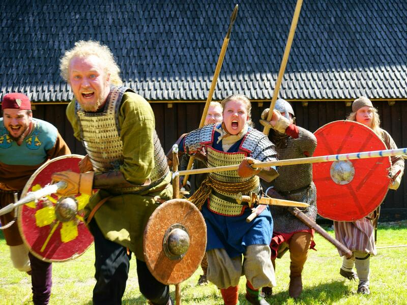 Bilde av menn utkledd som vikinger med sverd og skjold