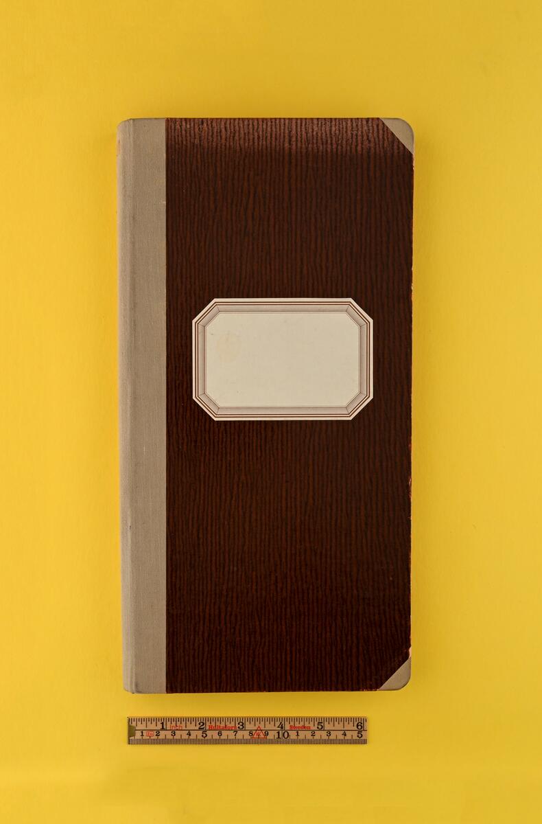 Kassabok med mönstrad rödbrun pärm och gråbeige tygrygg. På framsidan etikett utan påskrift. Sträcker sig från 1944-1947.