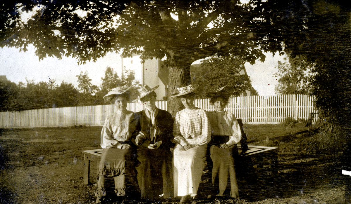 Fire kvinner sitter på torvet 1905.
Bilde er fra fotoalbum GM.036887.