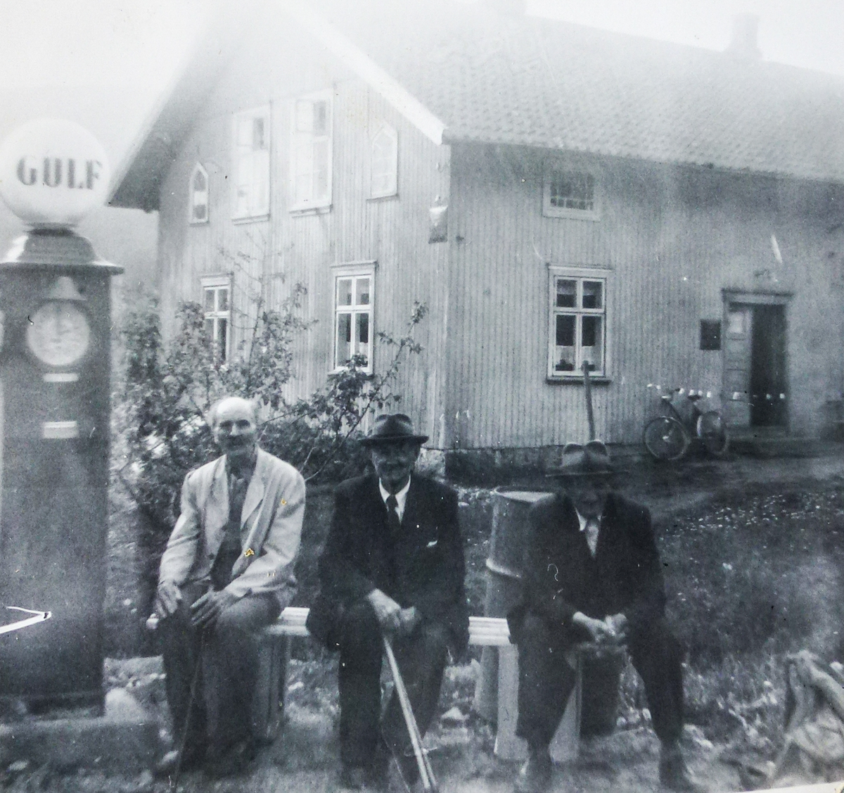 Fra venstre kjøpmann Truls Rugland, Gotfred Rugland, Torvald Tidemansen.  Huset bakenfor telefonsentral i bygda, tidligere ysteri.