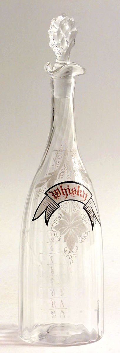 Glasskaraffel med propp, målangivelsene 1-12 på flasken.