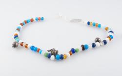 Komse, perlebånd til