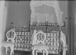 Interiør i et soverom. Her sees en dobbeltseng i metall med 