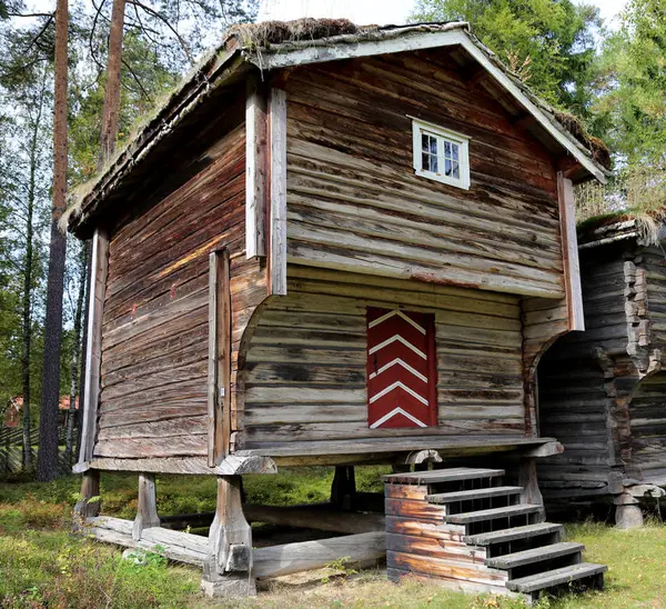 Stabbur fra Nedre Berger, Åmot med torvtak og rødmalt dør