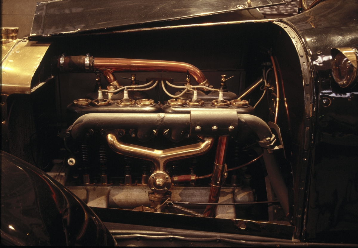 Scania-Vabis, modell 1911. Furhjulig personbil med öppet karosseri. Karossen är tillverkad av mahogny på ekstomme. Fyra sittplatser samt två uppfällbara extrasäten bak. Rak fyrcyl. fyrtakts bensinmotor på 4,4 liter. Fyra växlar , kulissväxel med spaken utvändigt placerad . Magnettändning. Kylarsag lyktor m.m. är tillverkade av mässing. Gasbelysning samt två "elektriska ögon på torpeden". Start med vev. Fartbroms på kardanaxel och handbroms på de två bakhjulen. Hjul med träekrar och stålfälgar.  30-36 hk enl katalog.
Tillbehör: Två sidoskydd av segelduk.