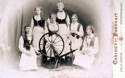 Foto av fire kvinner, alle sittende rundt en rokk, og alle e