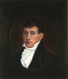 Portrett av eidsvollsmann Christopher F. Omsen.  Mann med kort, mørkt hår, mørk kledning og hvit skjorte med hvitt halsbind, kalvekryss  Innskrevet i oval.