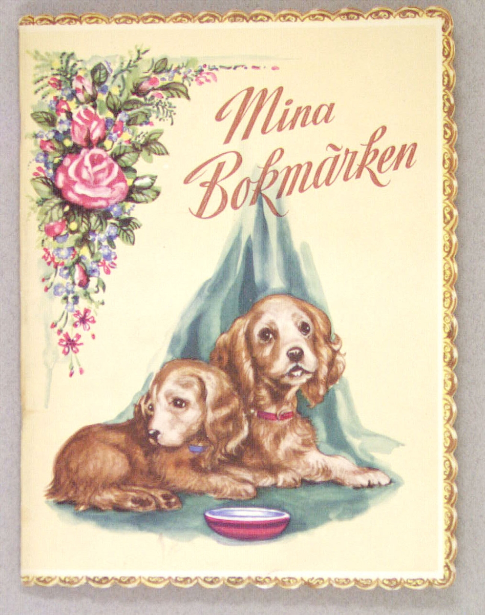 Ett bokmärksalbum med inklistrade bokmärken. På framsidan två hundar vid en matskål och i övre vänstra hörnet en rosenbukett. Har tillhört givaren Maria Hellquist, Sandviken.