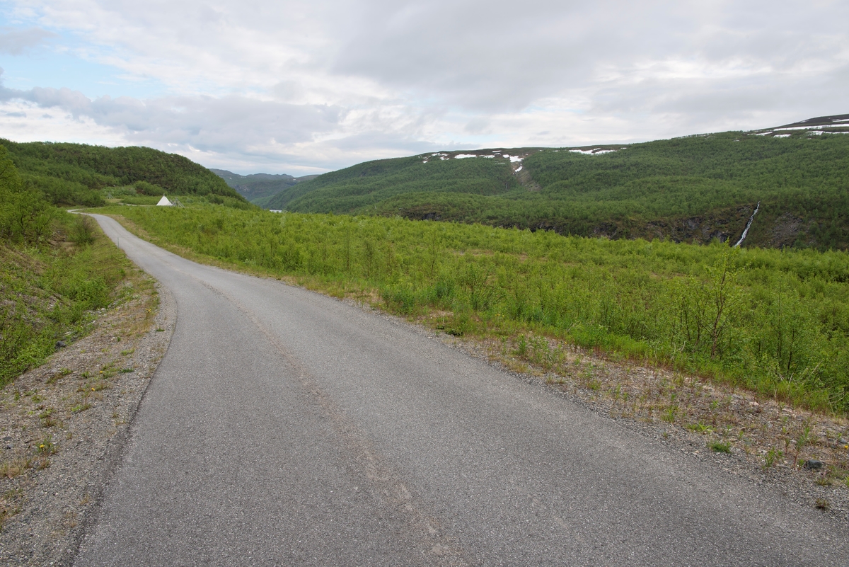 Veg og steinfylling i fjellandskap nær Altadammen, Alta, Finnmark. Fylling. Etter utbyggingen av Alta-kautokeino vassdraget ble endel steinmasser plassert rett nord for Altadammen i Sautso. Senere ble disse arealene beplantet. Steintipp. steindeponi.