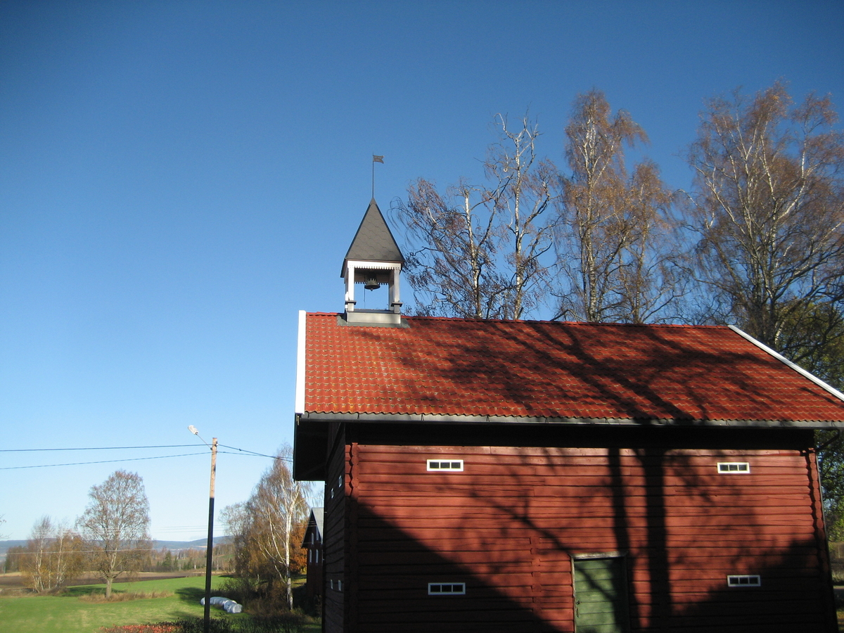 Klokketårnet på Dæhlin vestre har telttak og sveitserstildetaljer. Tårnet står på stabburet, og er i god stand.