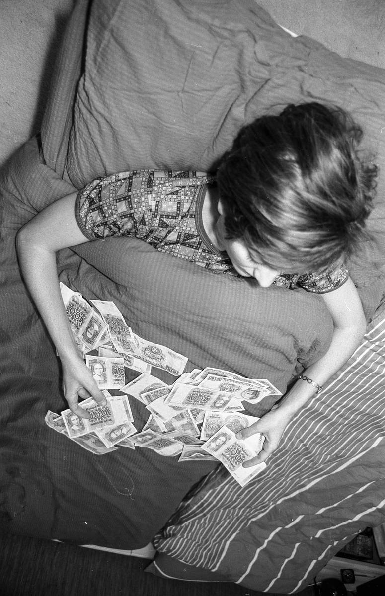 Sykepenger. Arrangert bilde av sengeliggende dame med pengesedler utover dynen.
Fotograf: ØB Ukjent