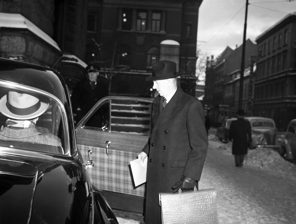 Statsminister Oscar Torp går inn i en ventende bil utenfor regjerningsbygningen i Akersgaten på vei til sitt siste statsråd hos Kongen.