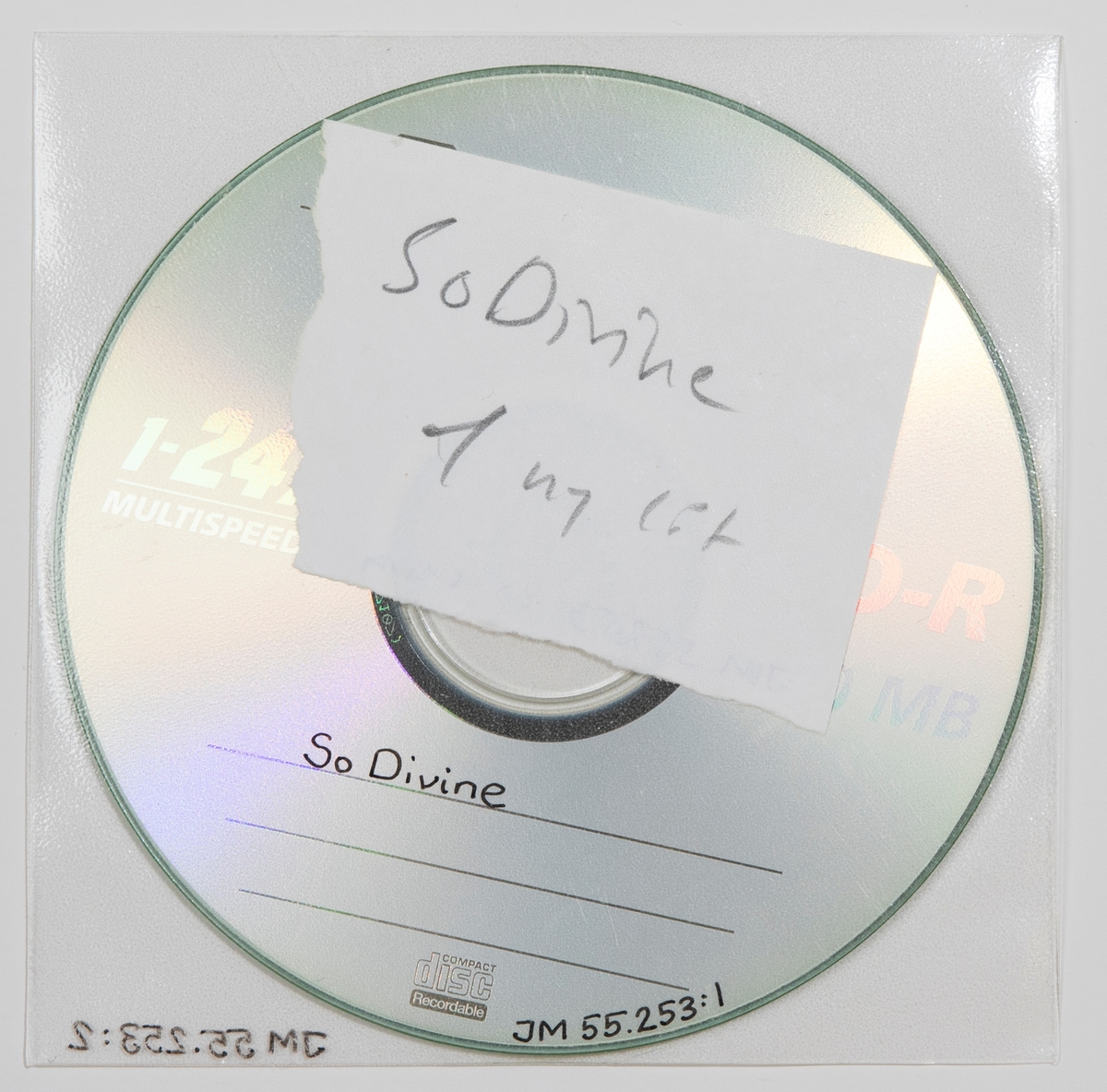 CD-skiva i plastficka. Inne i plastfickan ligger en handskriven papperslapp med texten: "So Divine 1 ny låt".

JM 55253:1, Skiva
JM 55253:2, Plastficka