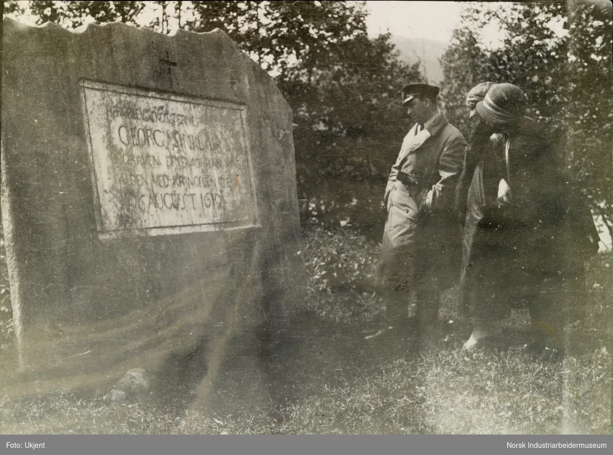 Personer står foran graven til Georg Sinclair ved Kvam kirkegård