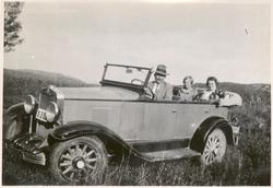 Mann og to kvinner i en bil.