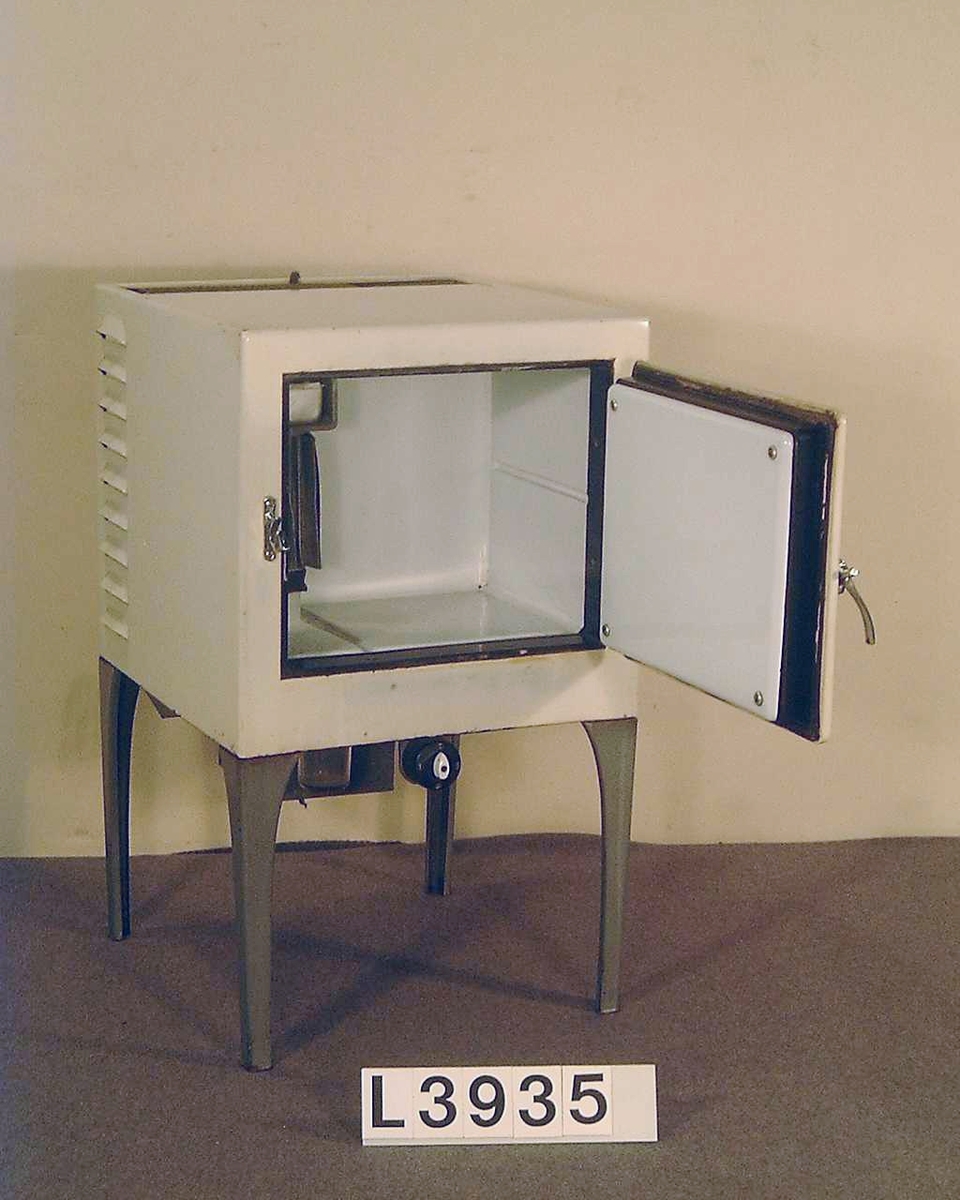 Electrolux lilla värmedrivna kylskåp på 28 liter. Kabinettet är i bengult och benen är gråmålade. Det mekansika kromade handtaget, har stängningsfunktion.