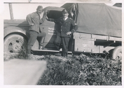 Tre tyske soldater ved tysk militærbil