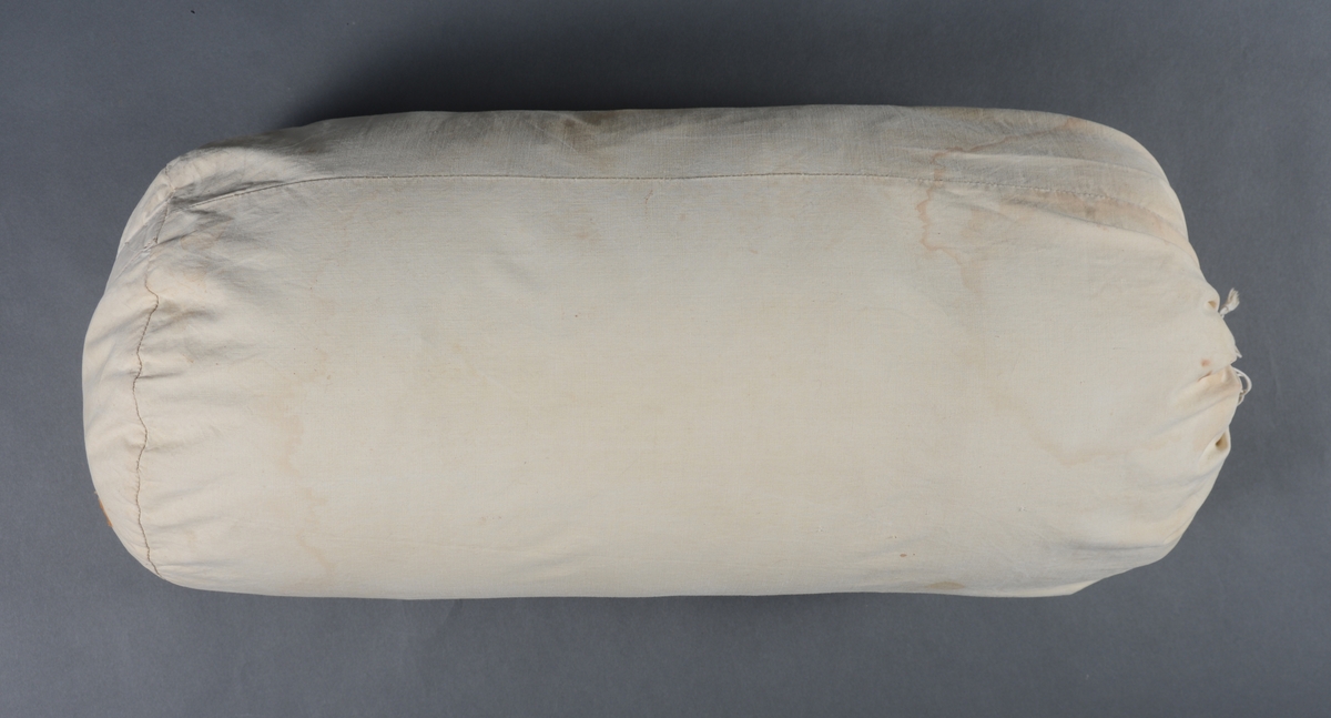 Sovepose med glidelås og trekk. Posen er sydd med halvmåneformet stykke i fotenden og rund form ved hodeenden.