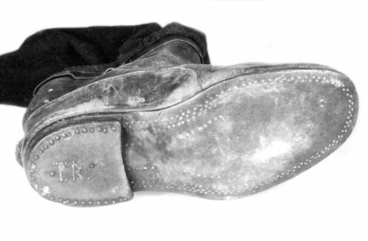 Støvlene har pluggede såler. De har skaft av vadmel foret med et noe tynnere stoff. Yttersiden har et mørkt gråmelert stoff, mens innsiden har mørkeblå farge. Skaftene går opp i en spiss på utsida og der er festet en lærstropp med knapphull i. I hælen er det slått inn spiker for initialene "TR". Støvlene er laget av giverens far, Oluf Rasch, i 1923 da giveren begynte som tømmermåler. Oluf Rasch var skomaker og håndverker i lærtøy på Terningmoen. Han var sersjant. Kjørestøvlene ble brukt under reise om vinteren, men ble tatt av under merking. 
En gang hadde giveren dem på under merking, 36 gr. kulde på Steinvik i Stor-Elvdal.