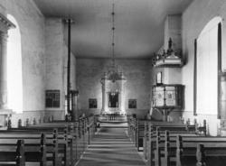 Interiør fra Skjeberg kirke med altertavle og prekestol.