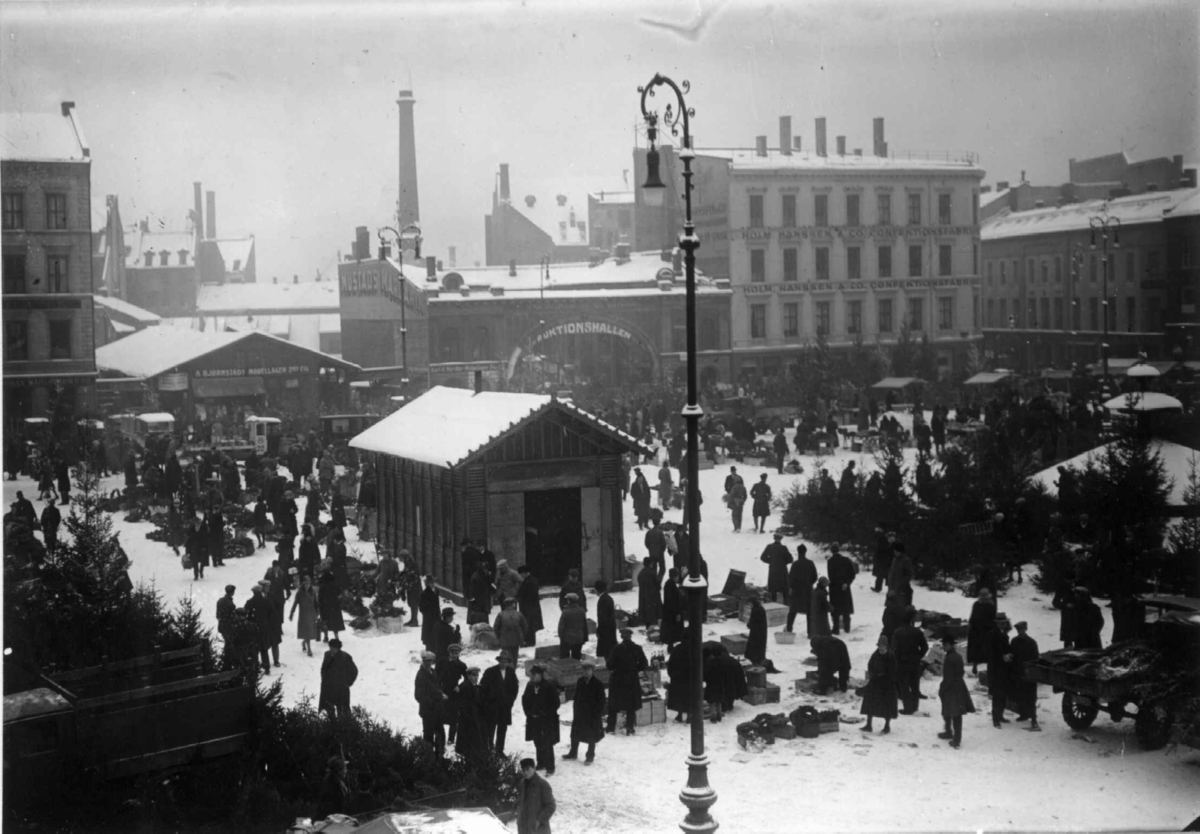 Youngstorget, Oslo 1930. Vinterbilde med juletrehandel på torget. Bybebyggelse rundt torget..