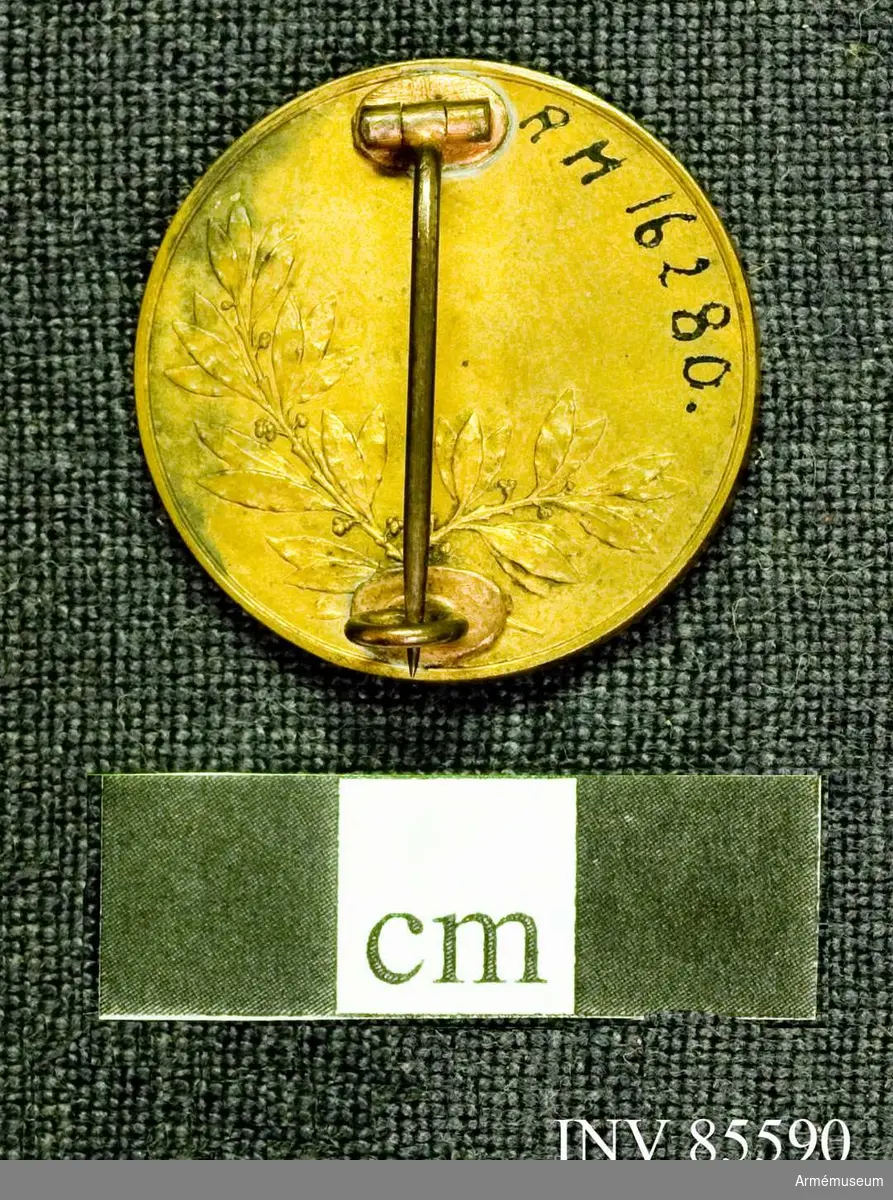 Grupp M.
Medaljen lika med n:16279 med den skillnad, att materialet är ljus brons. 
