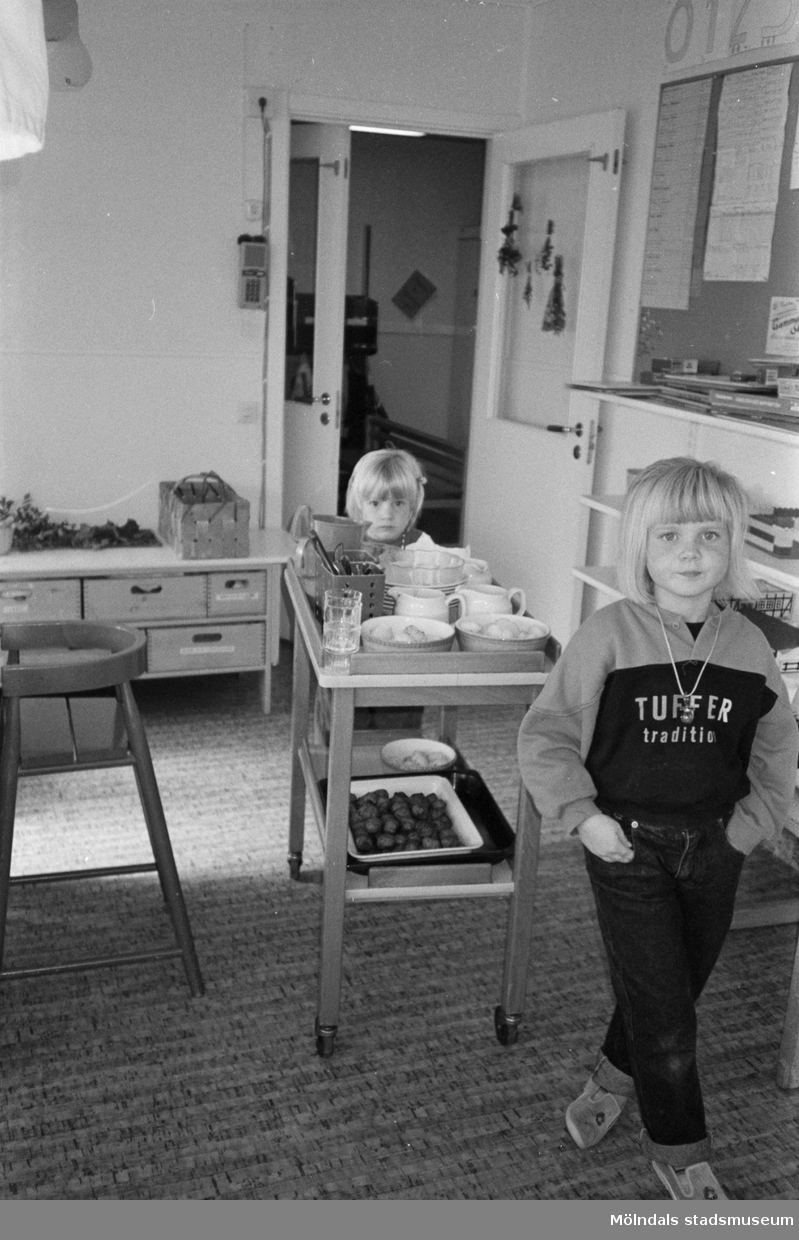 Dagisbarnen Anna-Maja och Rebecka rullar in matvagnen på Hoppetossan, Katrinebergs daghem, 1992.