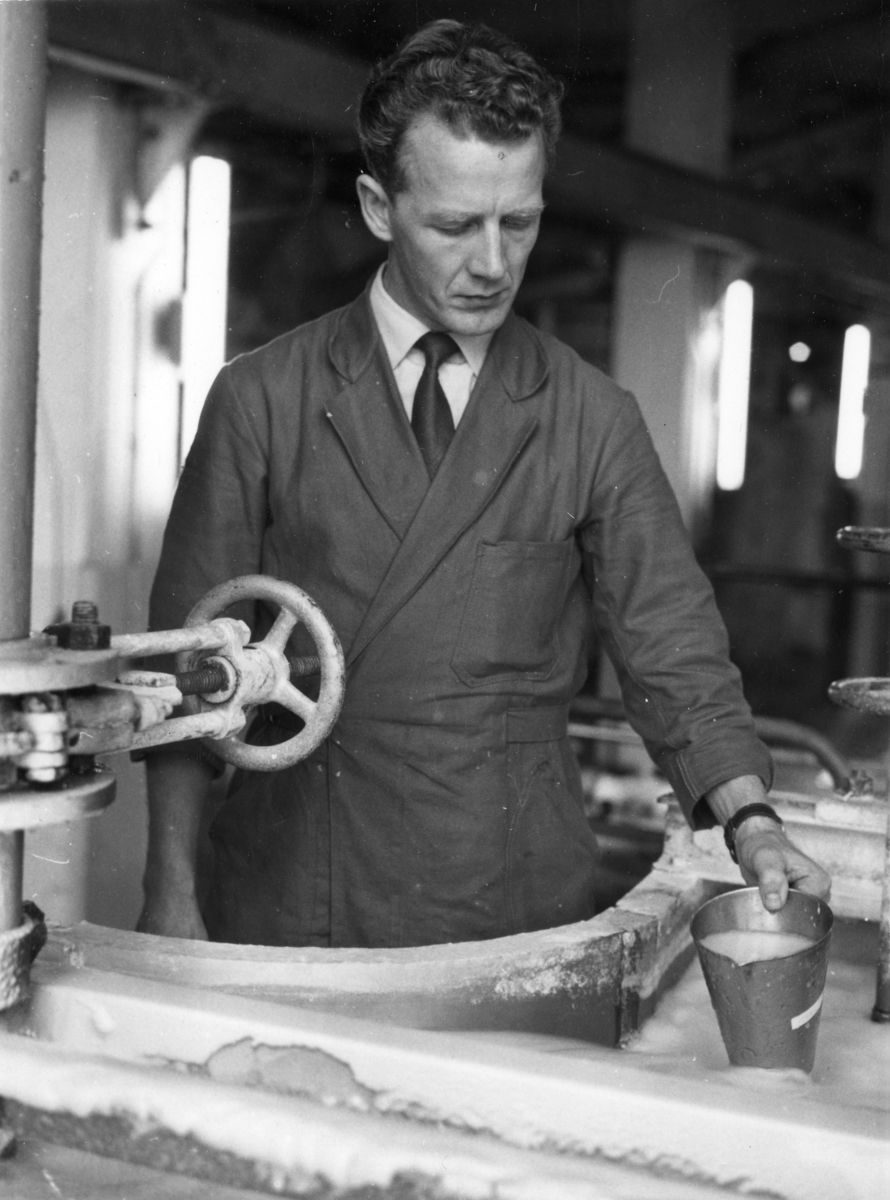 Reiftikontroll, malspads - och konertrotionsprov?? på Papyrus, den 15/11-1958.
En man arbetar vid en maskin. Bengt Lystrand.