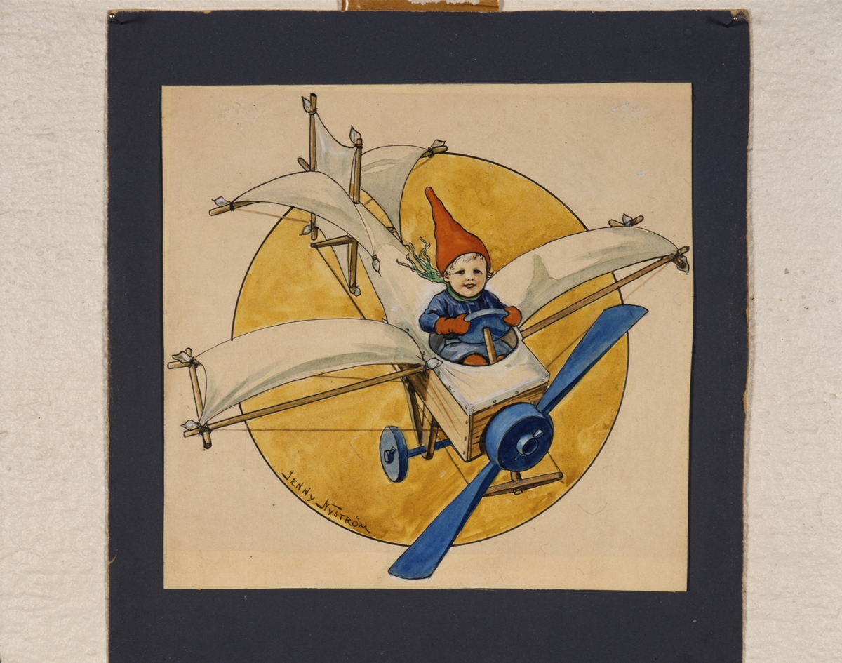 Förlaga till vykort, pojke i tomteluva i improviserad flygmaskin av tidig Bleriot-typ. I ram under glas. Ramen från 1950-talet.