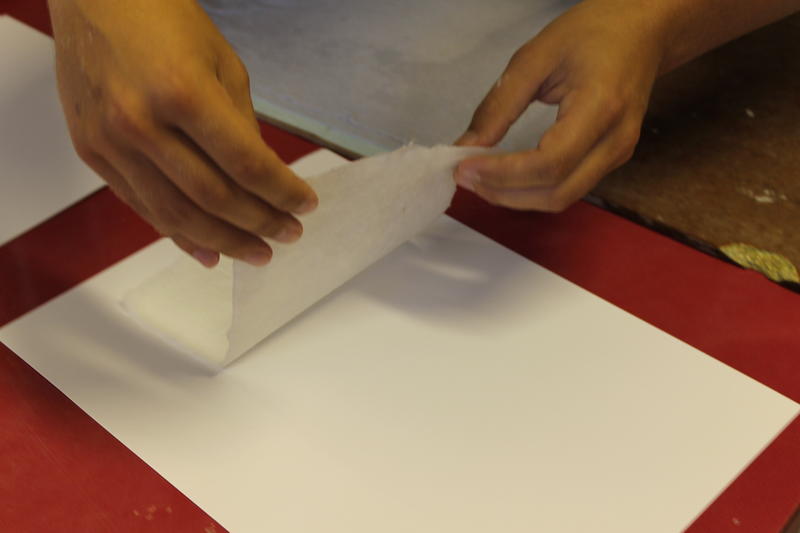 The paper is then placed on felt