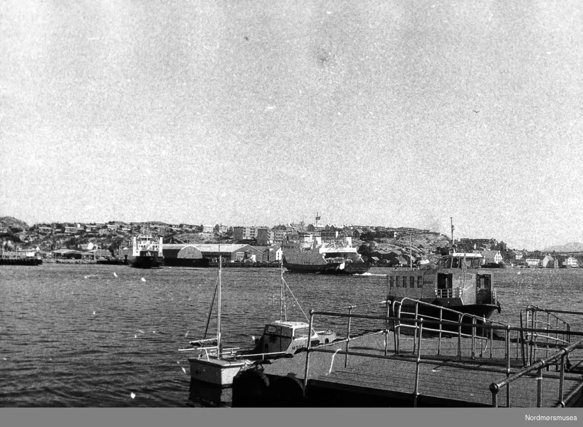 Foto sett fra Piren på Kirkelandet i Kristiansund, med Piren og havnebassenget i motivfeltet. Her ser vi Sundbåten Nordsund, som ble overlevert til Sundbåtvesenet den 2. februar 1965. prisen den gang var 220.000 kroner. Båten er 15.6 meter lang og veide 51.78 bruttotonn. Båten ble senere solgt til Småviken AS i Vestfold, våren 2005, for å settes inn i frakt av badegjester fra Tønsberg til Bolærene. Gjenkjøpt av KBBL. 
Vi ser også to ferger ute i havnebassenget. Den ene er Bilfergen Tustna som ligger ute i bassenget, mens den andre fergen er pendelferga BF KVERNES (info: Arnfinn Herkedal) og ligger nær Devoldholmen. Ellers så ser vi Gomalandet i bakgrunnen. Ukjent datering. Havnebassenget, sundbåten Nordsund, S/B Nordsund, SB Nordsund, B/F Tustna, BF Tustna, ferger, samferdsel, MRF, Piren, sjark, M-59-K, Fra Nordmøre Museums fotosamlinger. Kilde: ";Sundbåten. Folk over havna - fra fergemenn til Angvik";, av Sven Erik Olsen og Tor Olsen, side 122. Utgitt av HOLM Kristiansund, 2005.