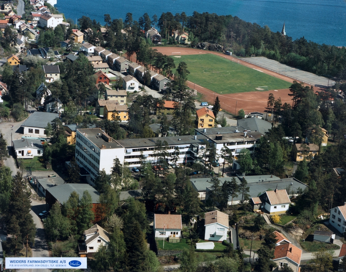 Luftfoto av landskap med fabrikkbygning.