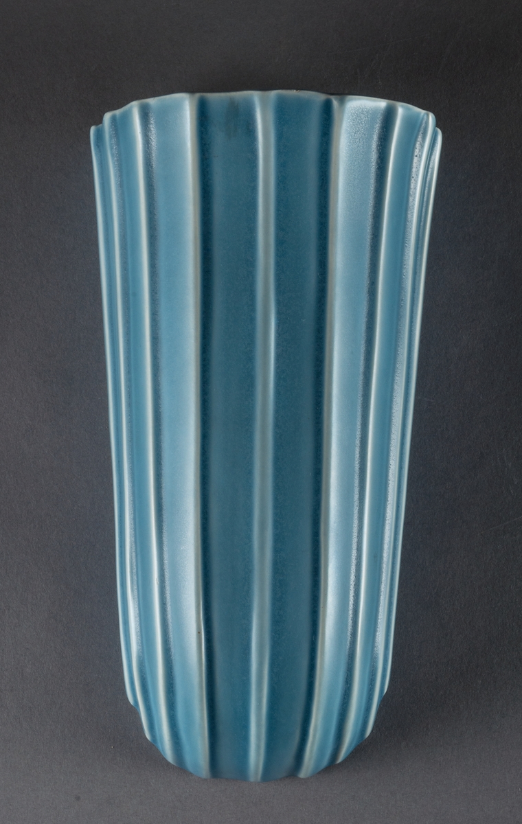 Väggvaser, 2 st, i fajans, Bobergs fajansfabrik, formgivare Ewald Dahlskog. Svagt S­svängd front med raka, uppåt något utvidgade sidor. Mönster av vertikala räfflor. Glaserade ljusblå. 
Modell: D93, 1935-53
Modell: D191 (liten), 1938-53