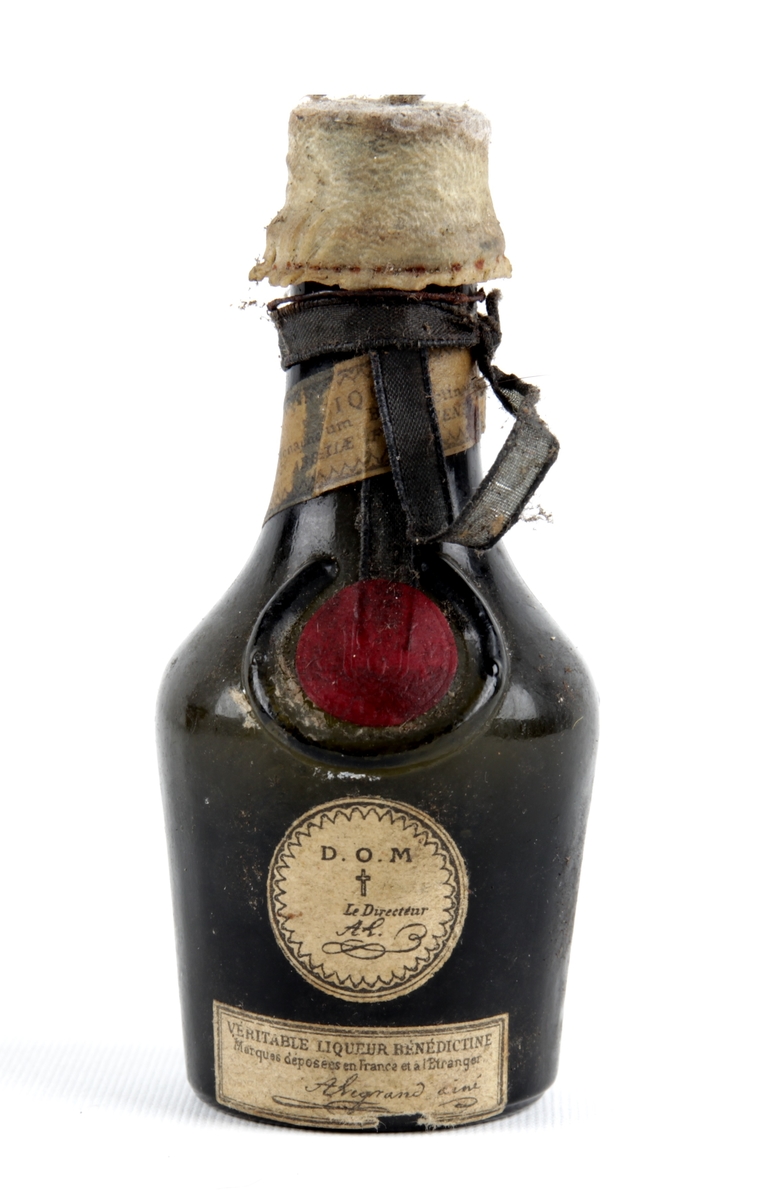 Liten likørflaske med forseglet kork.