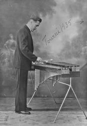 Mann, klær, xylofon.